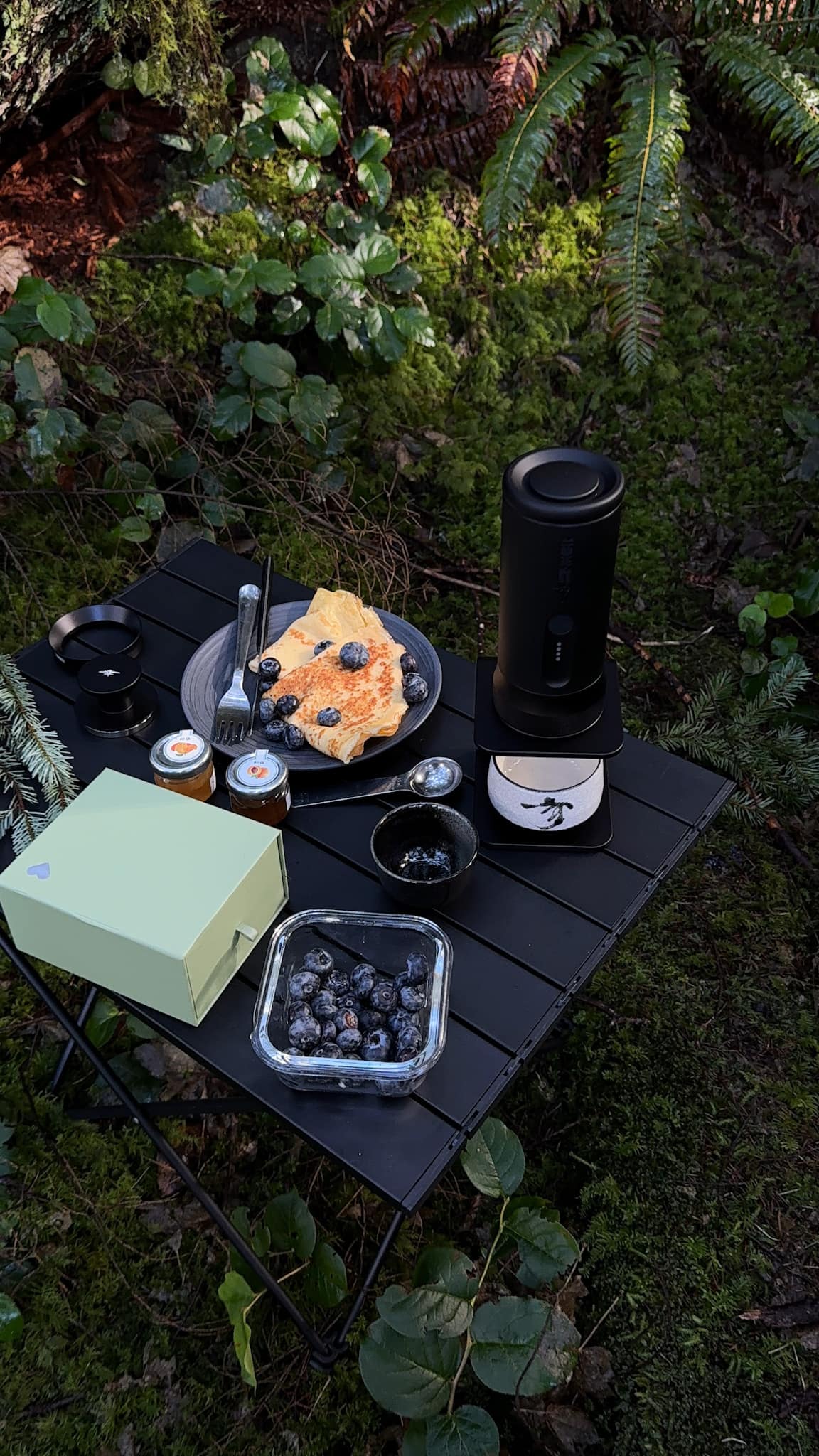 Espresso brewing outdoors in cool forest air