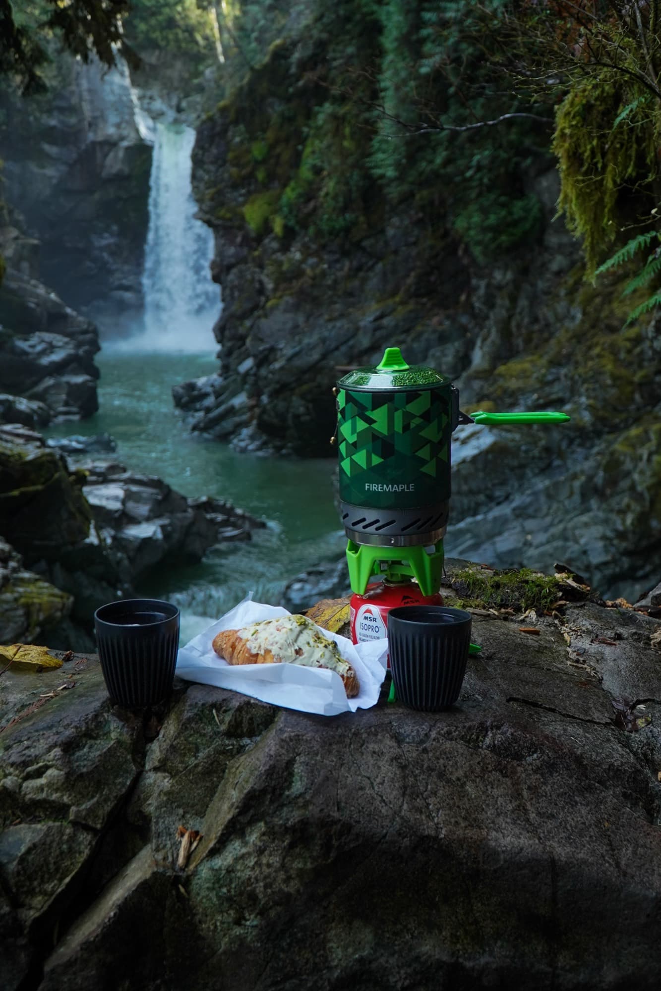 Product in nature — camp stove by waterfall